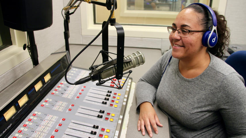 WTCC DJ in studio speaking into microphone