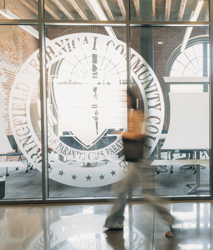 college student walking by student activities conference room in a blur