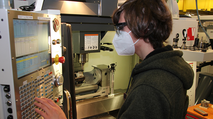 Advanced Manufacturing Student using 5 Axis Mill Machine