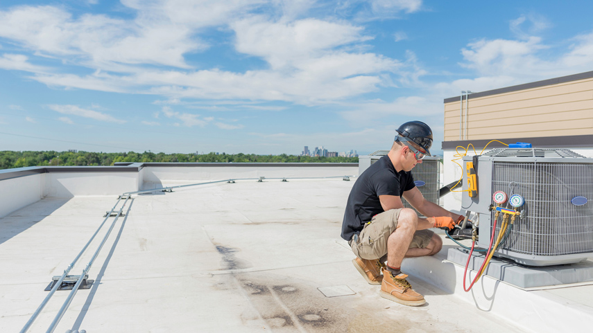 Refridgeration contractor working on roof