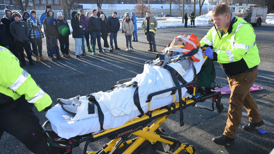 EMT class demonstration with student on stretcher