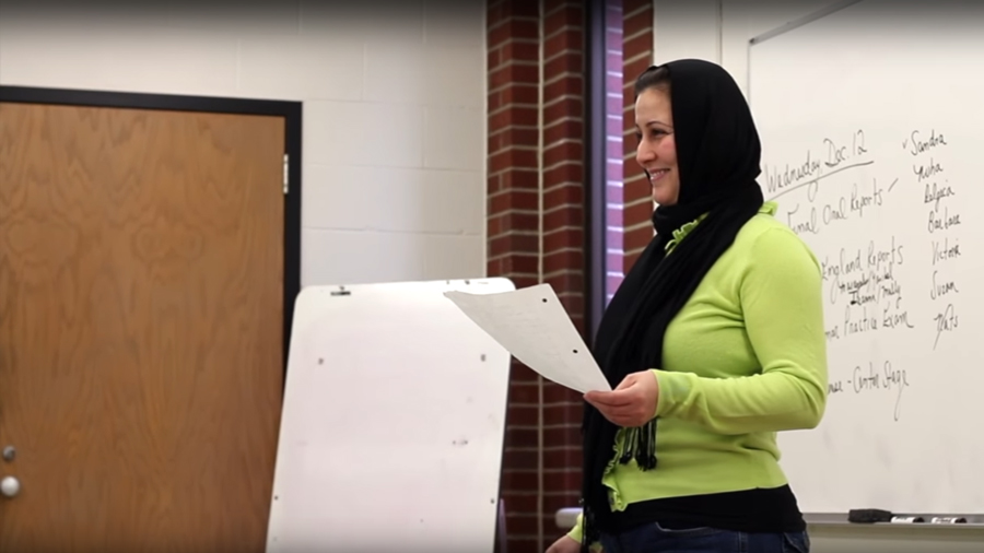 woman with hijab giving class presentation