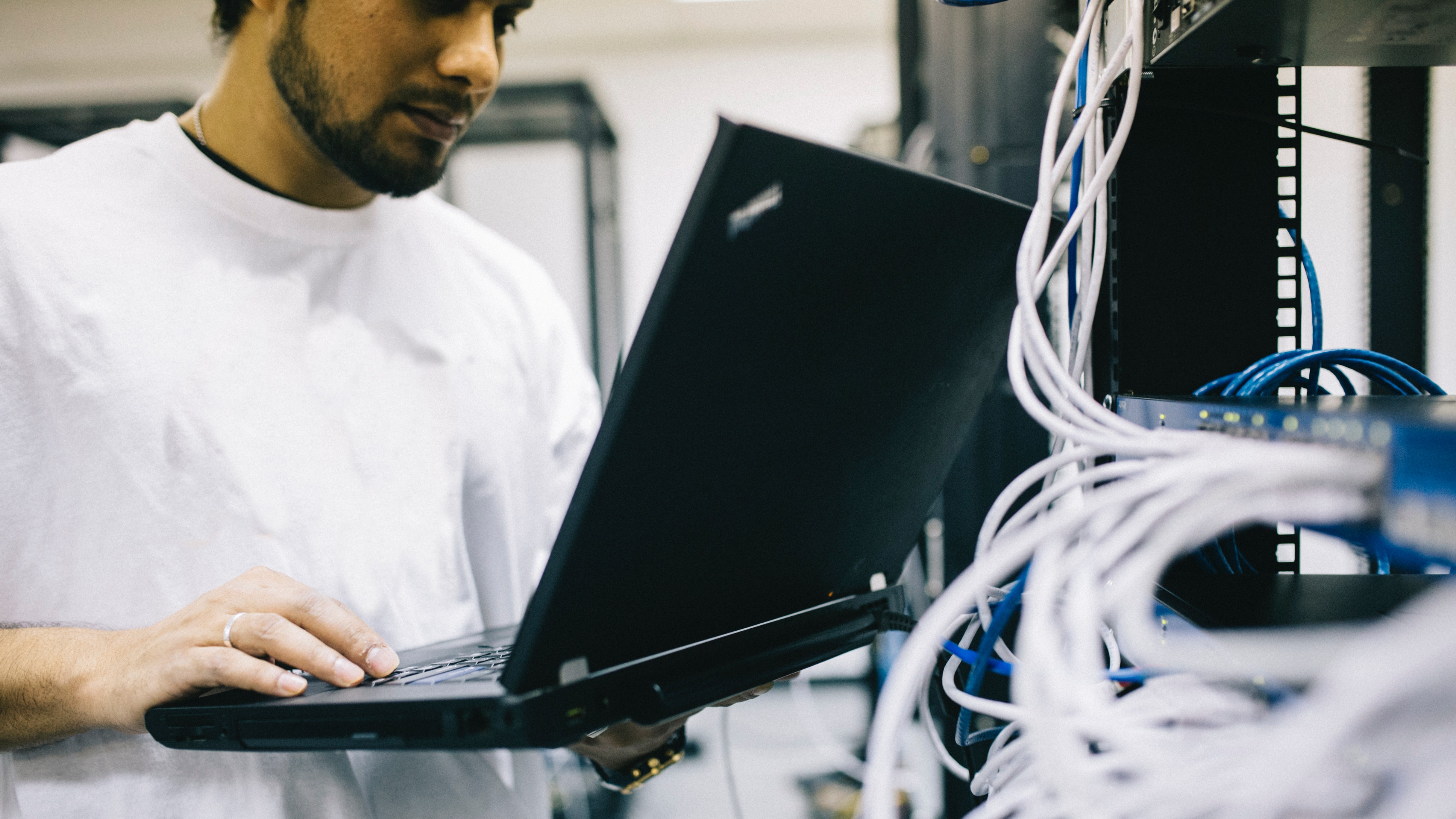 network technician on laptop connected to server